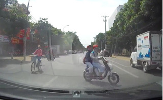 Clip nữ sinh đi xe đạp điện tạt đầu ô tô, thách thức tử thần tại Hà Nội