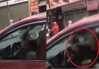Phẫn nộ với người phụ nữ vừa lái ô tô vừa bê bát ăn trên đường Hà Nội