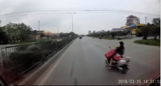 Hai mẹ con suýt chết vì vừa chạy xe máy vừa cởi áo mưa