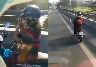 Clip HOT: 'Nữ ninja' phóng nhanh xe máy trên cầu vượt, bỏ hai tay lái để châm thuốc